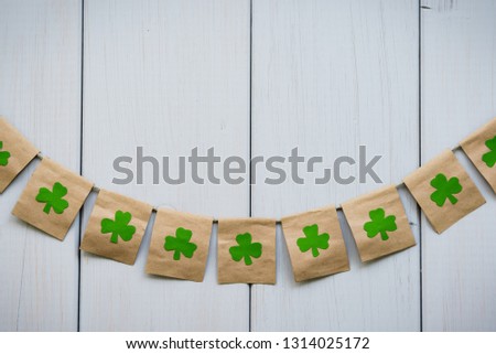 Happy St Patrick's Day. Flags with shamrocks clover on the wooden background