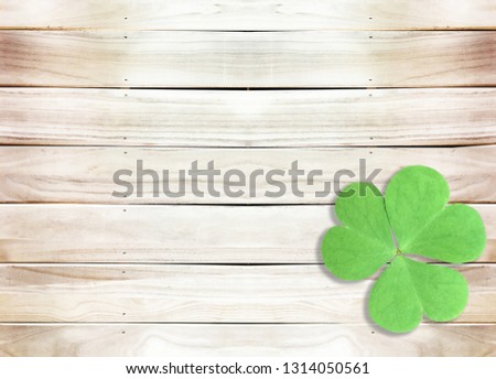 St. Patrick's Day Background with Green Shamrocks on Wooden Texture
