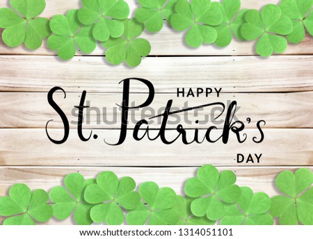 Happy St. Patrick's Day Background with  Green Shamrocks on Wooden Texture