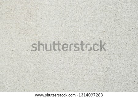 Light gray wall texture background. Facade relief plaster on the wall. Rough surface background. Wall covered with fine-grained relief finishing material for exterior work. 