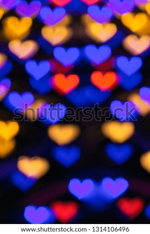 Different colored hearts bokeh background vertical