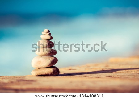 Closeup photo of a pebbles stack on the bridge over sea, spa stones, inner peace and life in balance concept
 Royalty-Free Stock Photo #1314108311