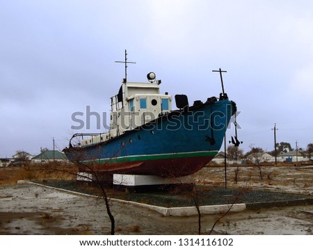 Real model of former sea boat on a pedestal as monument of passed days when Mo'ynoq was an active sea port on Aral sea. Picture taken in former piscatorial port Mo'ynoq (Moynaq) or Muynak, Uzbekistan