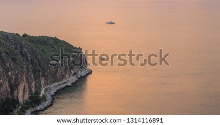 panoramic view of soft focus beautiful Earth place of mountain cape and sunset sea water surface with cruise ships, aerial landscape photography with empty copy space for your text or inscription 