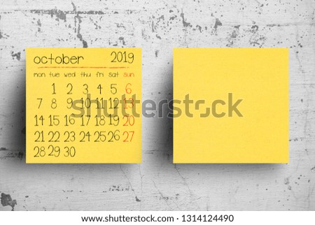 Sticky note on concrete wall, Calendar October