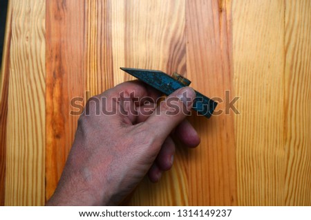 hammer in the hand of a man on a light background