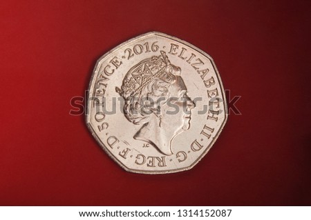 Coin dedicated to Beatrix Potter The tale of Peter rabit 50 pence isolated on the red background