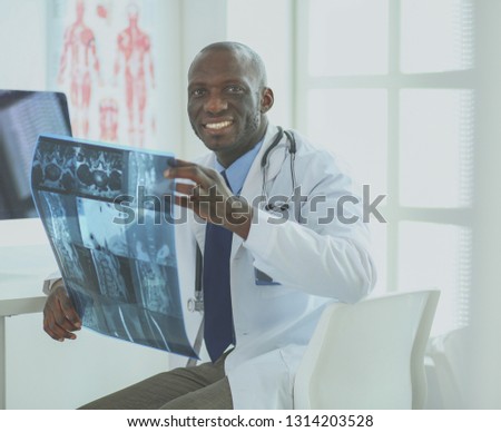 Portrait of an handsome black businessman standing in office