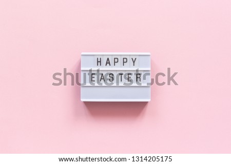 Lightbox text Happy Easter on pink paper background. Concept Easter minimal style Creative top-down composition Flat lay Greeting card.