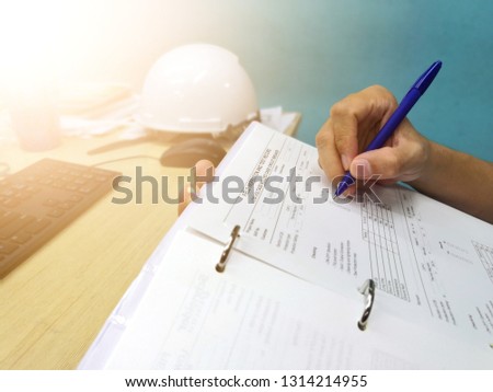 Engineer inspecting and checking datasheet.Engineers check the preventive maintenance documents after the operation.  Royalty-Free Stock Photo #1314214955