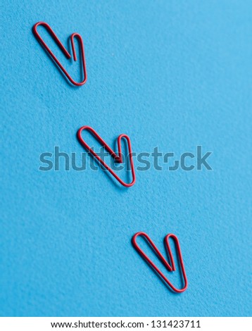 Paper clips on a blue background