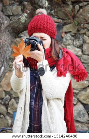 Young beautiful woman taking pictures to beech leaves in one of the most amazing beech forest in Europe, "La Fageda d'en Jorda", a nature paradise placed close to Olot village, Catalonia, Spain.