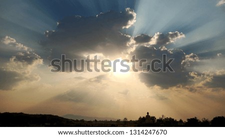sun behind large cloud