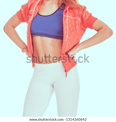 Young fit woman in sportswear showing her slim athletic body, image with toning