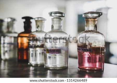 Colorful chemical in glass bottle with lable on the table in a college chemistry laboratory for experiment and research