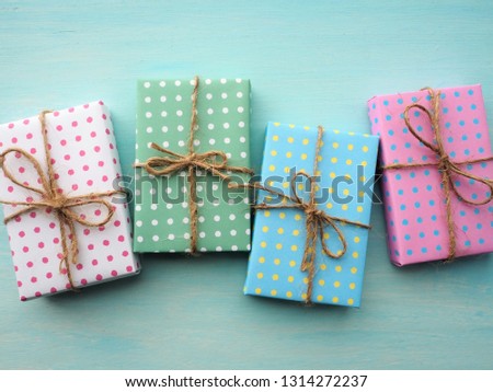 Colorful gift boxes with vintage pale blue painted wooden background, birthday and Christmas concept