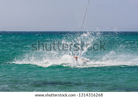 Picture of a Kite surfer performing difficult tricks in high winds. Extrme sports shot in Tarifa, Andalusia, Spain