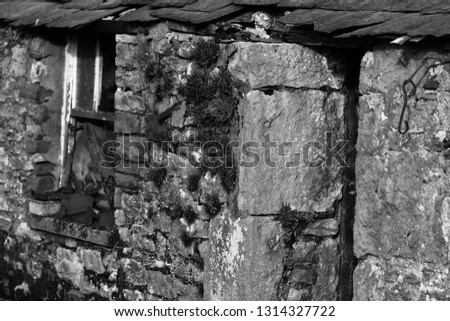 Building background textures, black and white picture of old stone stables and farm buildings in Cumbria, the Lake District
