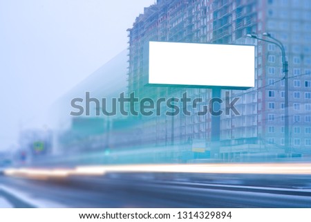 big billboard LED screen near the road in the city. with passing blurred lights of cars. outdoor advertising