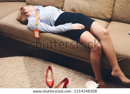 Business lady lying on the couch after a day at home.