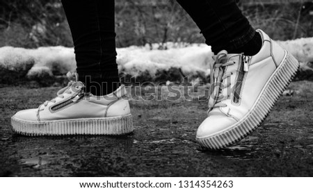 White sneakers on a dirty winter day