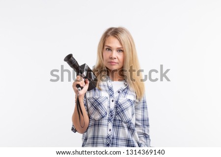 Technologies, photographing and people concept - blonde young woman with retro camera smiling over white background
