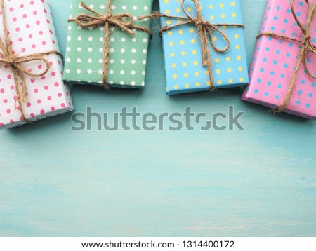 Frame of colorful gift boxes with vintage pale blue painted wooden background, birthday and Christmas concept