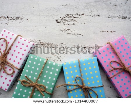 Frame of colorful gift boxes with vintage white painted wooden background, birthday and Christmas concept