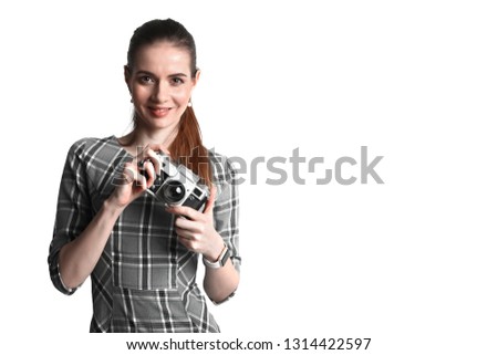 Smiling pretty woman in dress with a vintage retro camera isolated on white background.