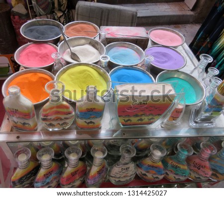  Colored sand to make souvenir bottles for tourists in the souk (market) of Old Dubai (UAE)                              