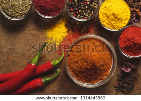 Red hot chili peppers. Place for text. Different types of Spices in a bowl on a stone background. The view from the top.