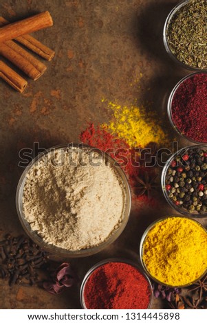 Ground Ginger . Place for text. Different types of Spices in a bowl on a stone background. The view from the top.