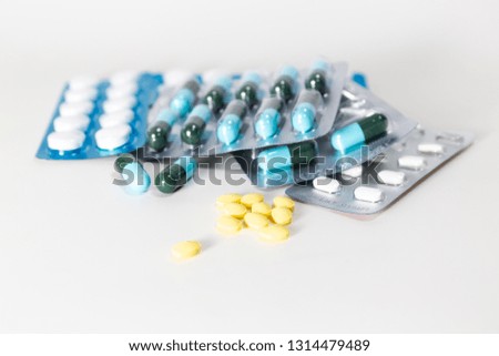Medical pills in white, blue and other colors. Pills in plastic 