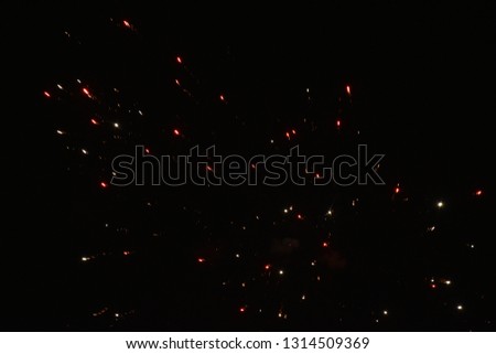 Salute of small lights in the dark night sky Royalty-Free Stock Photo #1314509369