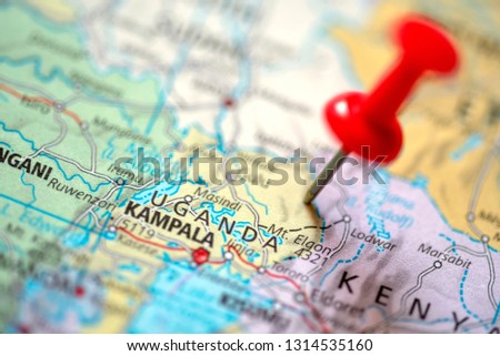 Push pin on the territory of Uganda on the world map