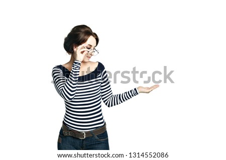 A young woman in a striped tight blouse  put your left hand palm up holding round glasses looking at the hand