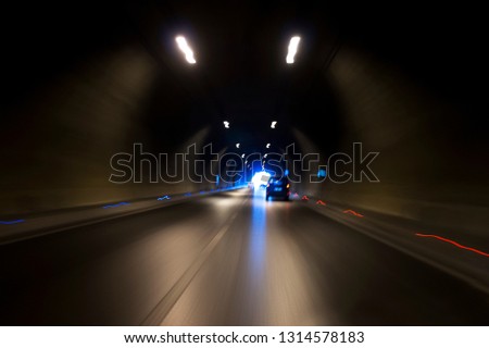 Long exposure Izmir Konak tunnel Turkey with lights, defocused cars and speed limit signs.