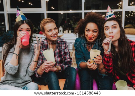 Portrait of cheerful asian, african, and caucasian female friends joking at party. Celebration concept