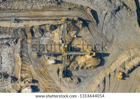 Aerial view of sandpit and factory plant producing sand materials for construction industry. Top view of industrial place. Photo captured with drone.