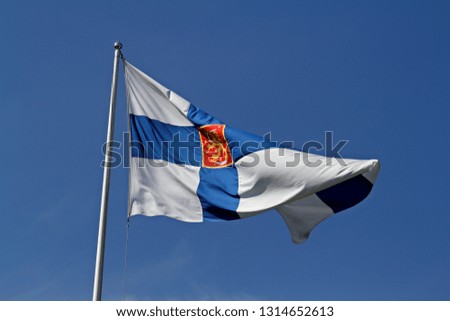 Finlands state flag with lion figure in red  rectangle flying in the air