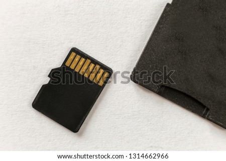 Close-up of micro SD memory card and SD adapter isolated on white copy space background. Modern technology concept.
