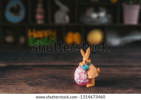 Easter decorative bunny on a wooden background.