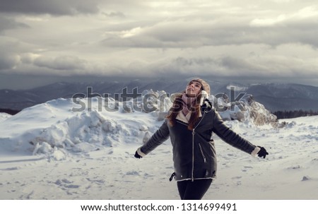 Girl on top of mountain in snowy weather