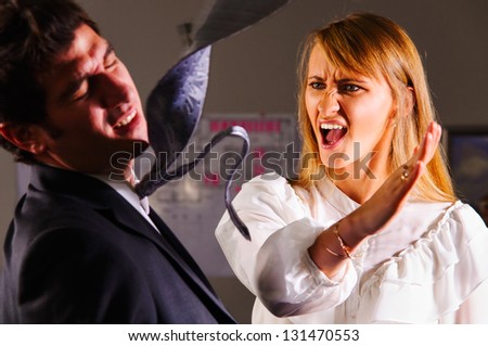 angry businesswoman is slapping across the businessman's face Royalty-Free Stock Photo #131470553