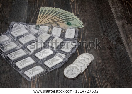 Silver coins, silver bars and fiat money.