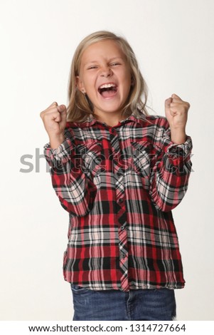 Portrait of a girl with long blond hair who laughs. White background
