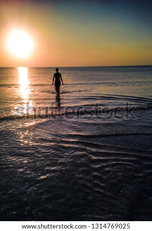 woman in evening sea surf