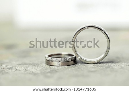 Wedding rings of gold, silver, palladium metal with diamonds, zircons and gems