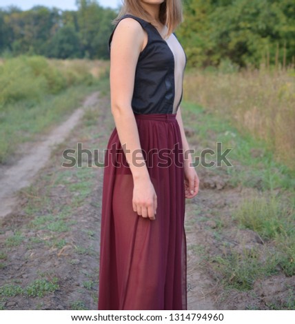 Young woman poses for a photographer on a photo shoot in the forest