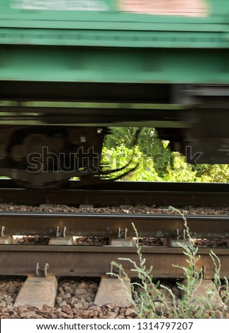 The moving train. Railroad. The train wheels running. Train movement. Blurred motion.